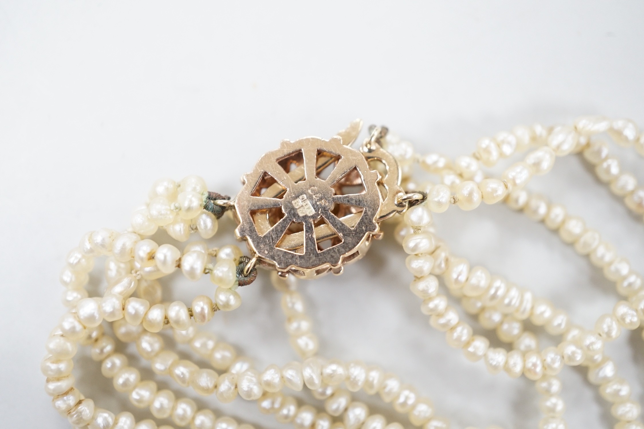 A 1960's Cropp & Farr multi strand seed pearl necklace, with 9ct gold, citrine and split pearl set clasp, 46cm.